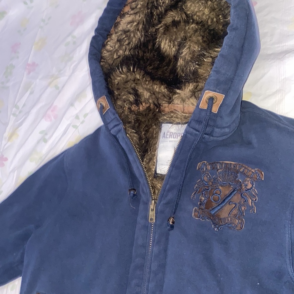 deep navy type blue on outside and thick warm fur on interior hood for winter.